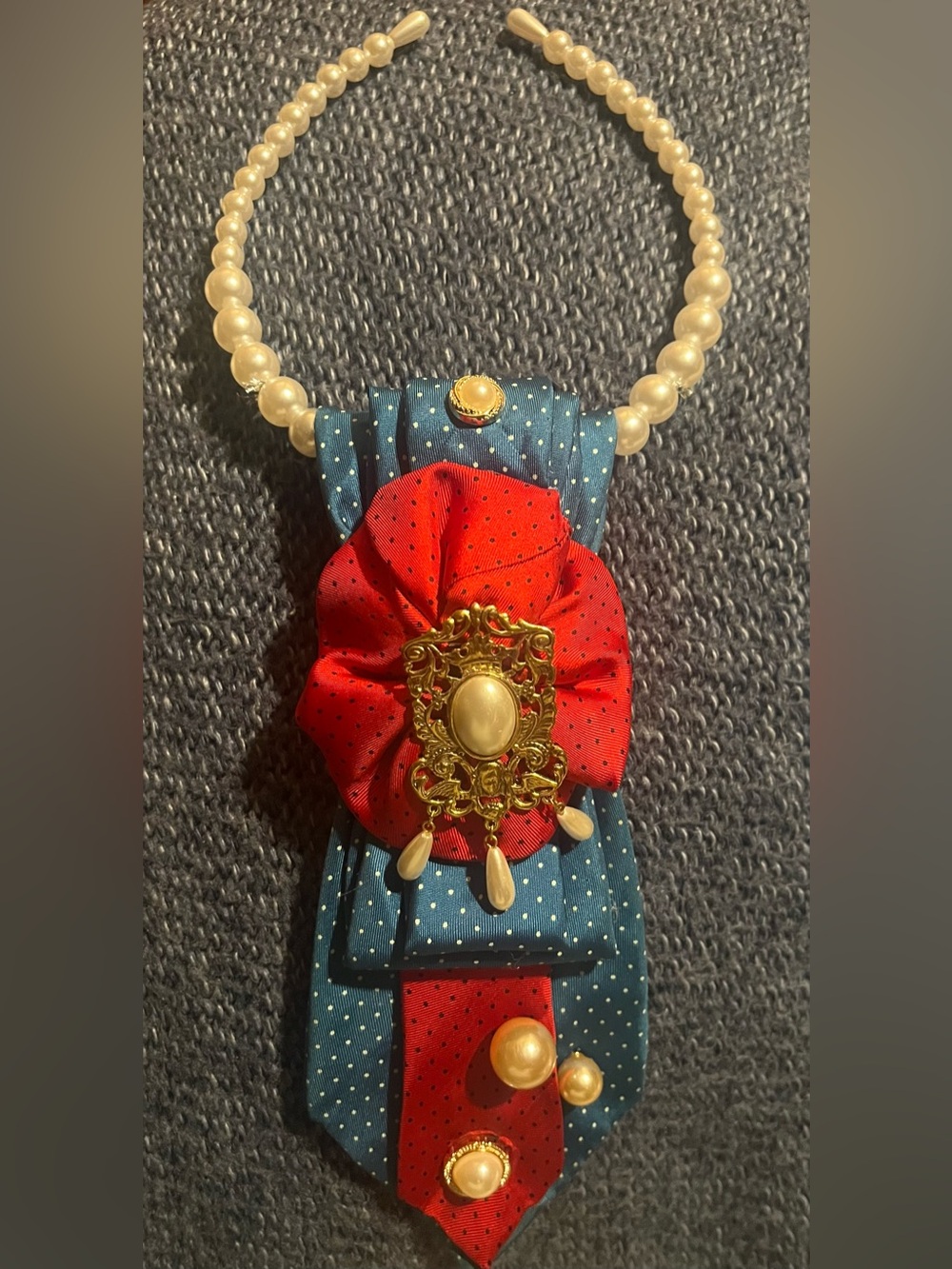 Red Rosette and Blue Polka Dot tie with pearl necklace and accents.